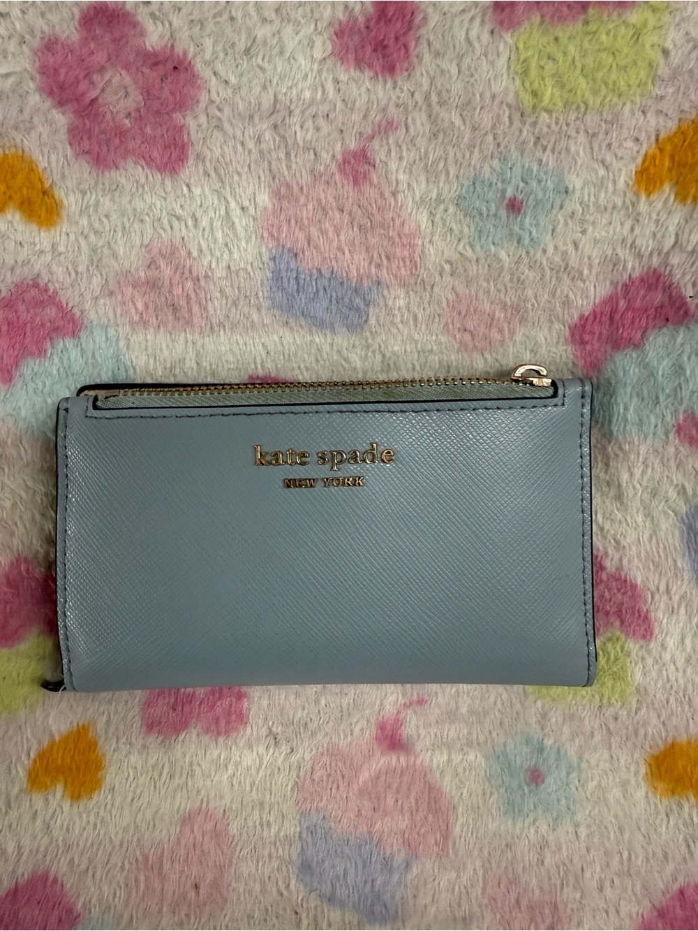 kate spade light blue Saffiano zip wallet with gold logo